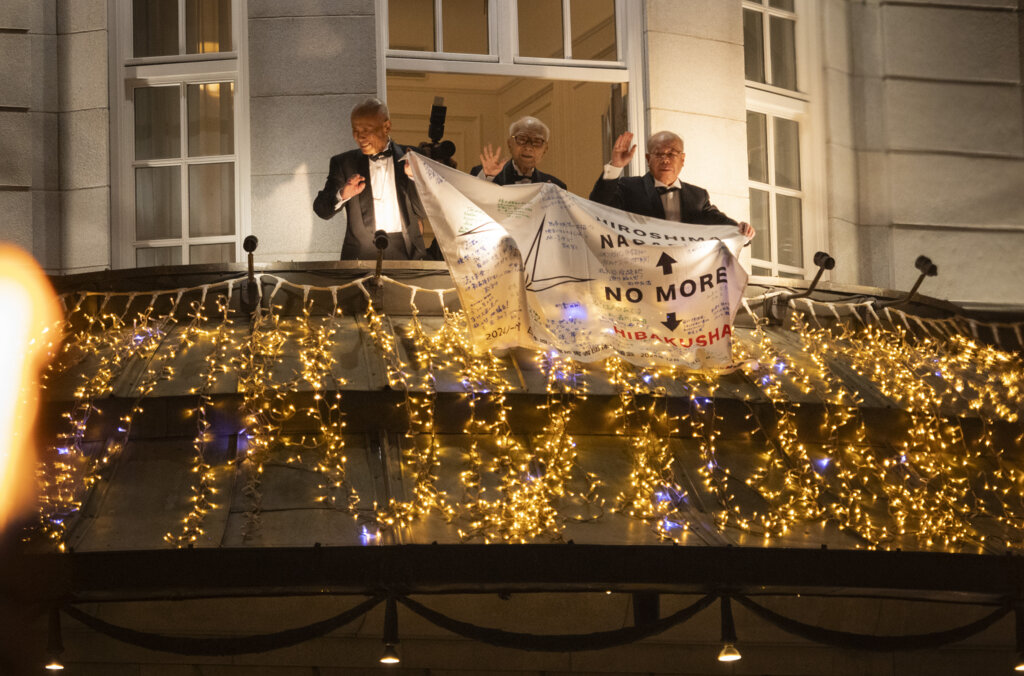 Three men on a balcony